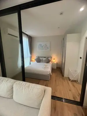 a bedroom with two beds and a large mirror at Title Halo Nai Yang Тайтл Хало Най Янг operated by OK Group in Nai Yang Beach