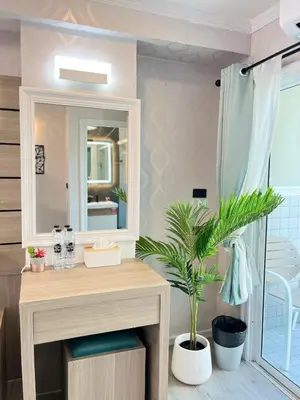 a bathroom with a sink and a mirror at APK Hillview Hotel in Patong Beach