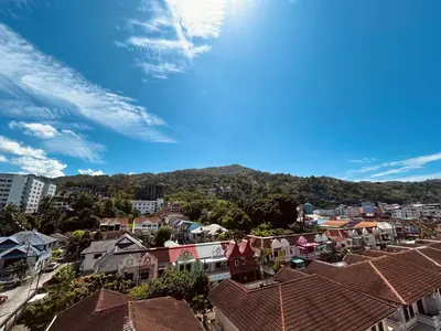 a view of a city with houses and a mountain at APK Hillview Hotel in Patong Beach