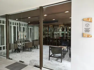 a dining room with glass doors and a table and chairs at 4 Floor - The Base Downtown Condominium next to Central Shopping Mall in Phuket Town