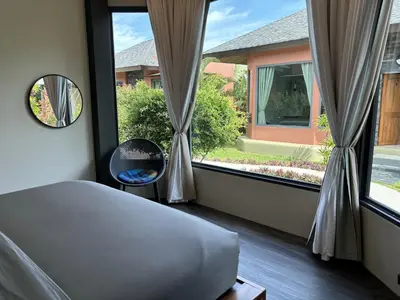 a bedroom with a bed and a large window at Ingsala by CafeAtLuv22 in Ban Bo Rae