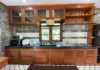 a kitchen with wooden cabinets and a sink at Charming and Exotic Seaview 2-Bedroom House in Patong in Patong Beach