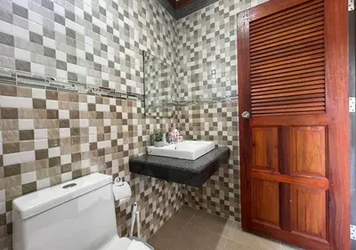 a bathroom with a toilet and a sink at Charming and Exotic Seaview 2-Bedroom House in Patong in Patong Beach