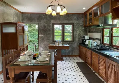 a kitchen with a wooden table and a dining room at Charming and Exotic Seaview 2-Bedroom House in Patong in Patong Beach