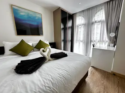 a bedroom with a swan decoration on a bed at Palmetto Park Condominium in Karon Beach