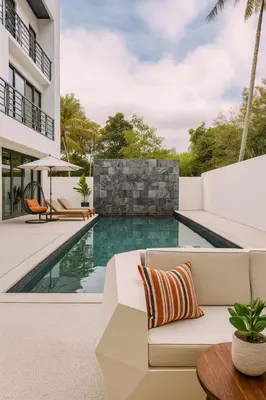 a living room with a white couch and a swimming pool at The Lush Apartments & Suites in Pilai Beach
