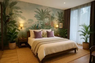 a bedroom with a large bed with plants on the wall at The Lush Apartments & Suites in Pilai Beach