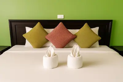 a bed with four pillows and two bunny heads at Srisuksan Klong Muang Beach in Klong Muang Beach
