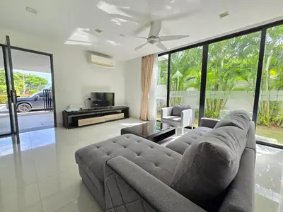 a living room with a couch and a tv at Laguna Park 2 Villa 3 bedroom in Ban Phru Champa