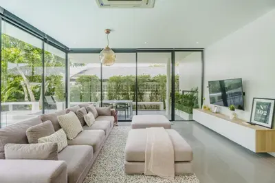 a living room with a couch and a tv at Harmony Exclusive Villa Bang Tao Phuket in Ban Thalat Choeng Thale