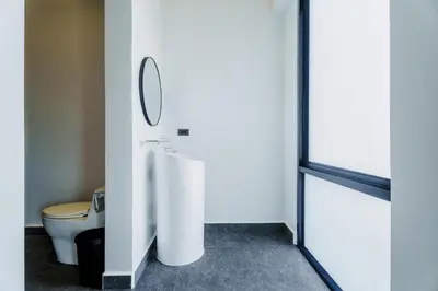a bathroom with a toilet and a mirror on the wall at Harmony Exclusive Villa Bang Tao Phuket in Ban Thalat Choeng Thale
