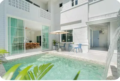 a house with a swimming pool and a patio at Patong Seven Heaven in Patong Beach