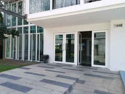 an entrance to a building with glass doors at 6 Floor - Studio room at OZC near Kata beach in Kata Beach