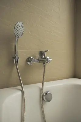 a bath tub with a shower with a shower head at Tantawan house - Kamala beach in Kamala Beach