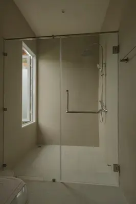 a shower with a glass door in a bathroom at Tantawan house - Kamala beach in Kamala Beach