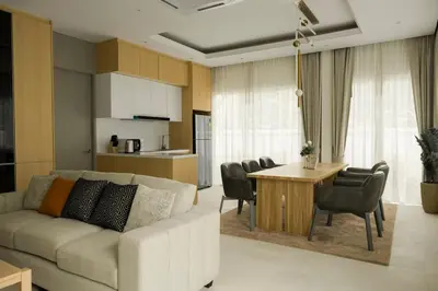 a living room with a couch and a table and a kitchen at Tantawan house - Kamala beach in Kamala Beach