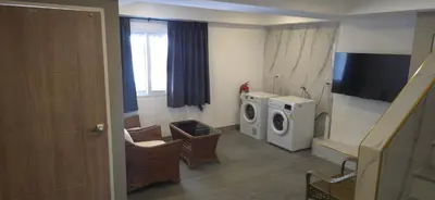 a bathroom with a washing machine and a tv at Andaman Seaview house rooftop 2 in Patong Beach