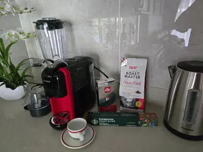 a counter top with a coffee maker and a cup at Beachside Lagoon Bang Tao Laguna by OK group in Ban Thalat Choeng Thale