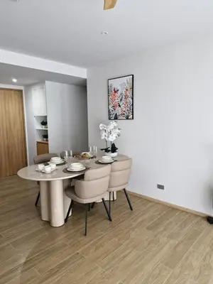 a dining room with a table and chairs at Beachside Lagoon Bang Tao Laguna by OK group in Ban Thalat Choeng Thale