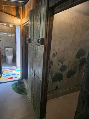 an open door to a bathroom with a toilet at THE REAL ESCAPE - Koh Yao Noi in Ko Yao Noi