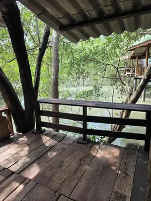 a bench on a wooden deck with a view of the water at THE REAL ESCAPE - Koh Yao Noi in Ko Yao Noi