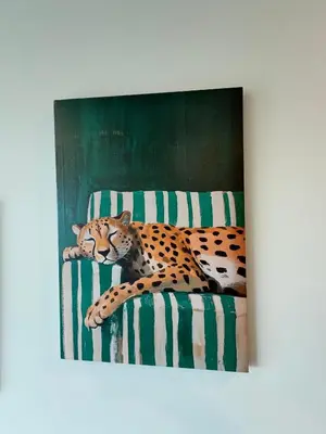 a painting of a leopard laying on a chair at New Stylish Cozy One-bedroom Apartment in Bangtao, Phuket, Near EDC in Ban Thalat Choeng Thale