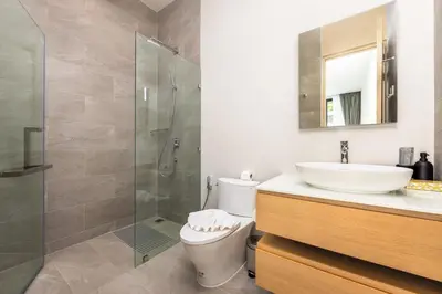 a bathroom with a toilet and a sink and a shower at Villa Noa Modern 2-Bedroom with Private Pool in Rawai Beach