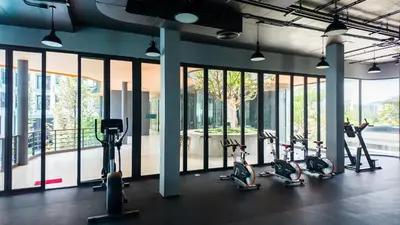 a gym with several treadmills and elliptical machines at Apartment studio in Bellevue Lagoon on Bang Tao in Laguna Phuket