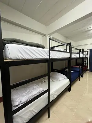 a room with three bunk beds in a room at Klong Muang Hostel คลองม่วงโฮสเทล in Ban Ko Kwang