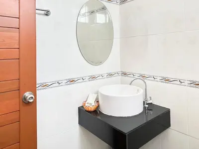 a bathroom with a sink and a mirror at Saiinam Laguna Inn in Ban Thalat Choeng Thale