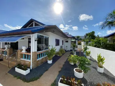 a house with potted plants in front of it at Villa Jasmine in Rawai Beach