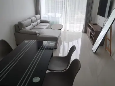 a living room with a couch and a table at Kamala falls seaview 1 bedroom in Phuket Town