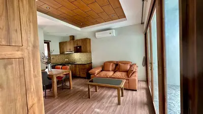 a living room with a couch and a table at Villa avec piscine privée in Kamala Beach