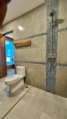 a bathroom with a toilet and a shower at Villa avec piscine privée in Kamala Beach