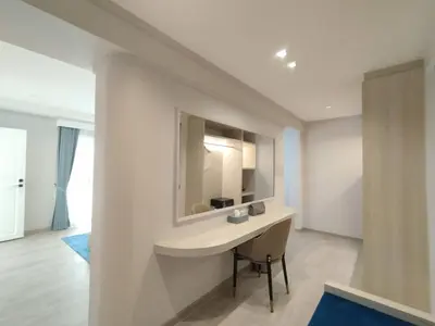 a bathroom with a sink and a mirror on a wall at Villa Atchara in Patong Beach