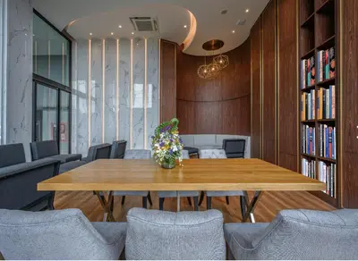 a dining room with a wooden table and chairs at 1 bedroom Mida Grande Resort, Phuket in Surin Beach
