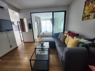 a living room with a couch and a table at cen 1 bed room862 in Ban Rangeng
