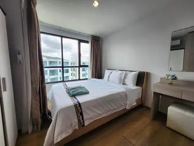 a bedroom with a bed and a large window at cen 1 bed room862 in Ban Rangeng