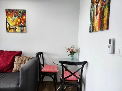a living room with a table and chairs and a couch at cen 1 bed room862 in Ban Rangeng