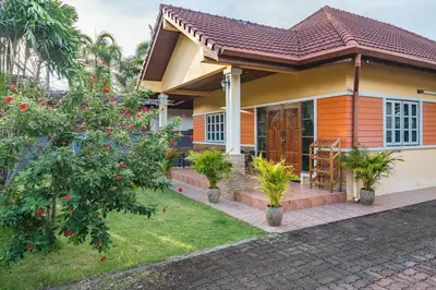 a house with trees and plants in front of it at Areca Holiday Home 1, Bangtao Beach in Ban Thalat Choeng Thale
