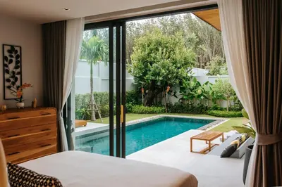 a bedroom with a bed and a swimming pool at Botanic Modern loft Villa Private Pool 10 min BangTao in Ban Pak Lak
