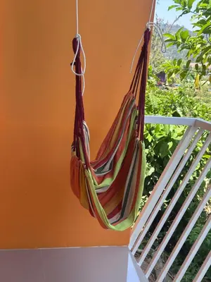a hammock hanging on the side of a house at Pangea Stay in Kathu