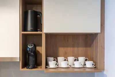 a row of coffee cups and a coffee machine on a shelf at New studio near Boat Avenue by Lofty in Bang Tao Beach