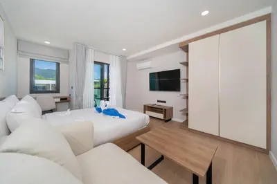 a hotel room with a bed and a couch at New studio near Boat Avenue by Lofty in Bang Tao Beach