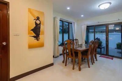 a dining room with a table and chairs at First Ao Nang Private Pool Villa in Ao Nang Beach