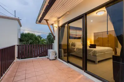 a balcony of a house with a bed in a bedroom at First Ao Nang Private Pool Villa in Ao Nang Beach