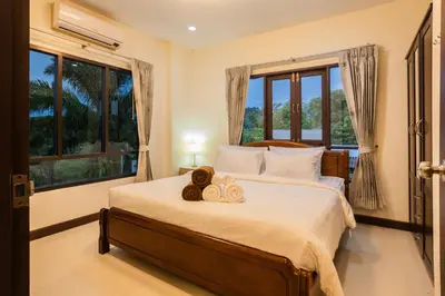a bedroom with a bed with towels on it at First Ao Nang Private Pool Villa in Ao Nang Beach