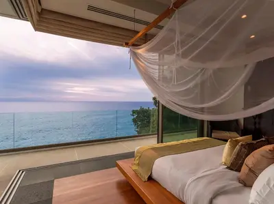 a bedroom with a bed and a large window at Baan Paa Talee Estate - SHA Extra Plus in Kamala Beach