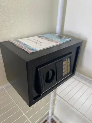 a microwave with a book on top of it at Muttafa House in Nai Yang Beach