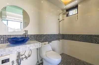 a bathroom with a toilet and a sink and a mirror at V232 Private 4BR Pool Villa Near Big Buddha&Gym in Chalong